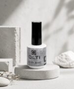 OLTI Beton Base nail polish bottle with a tall black cap on a round concrete pedestal.