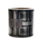 Roll of decorative black-and-gray tape with an abstract grid/digital pattern wrapped around a cylindrical core.